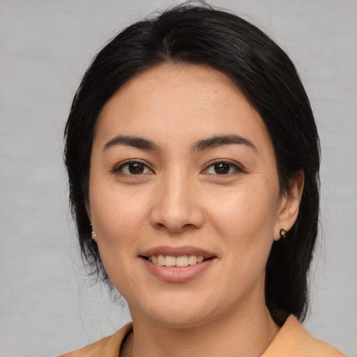 Joyful asian young-adult female with medium  black hair and brown eyes