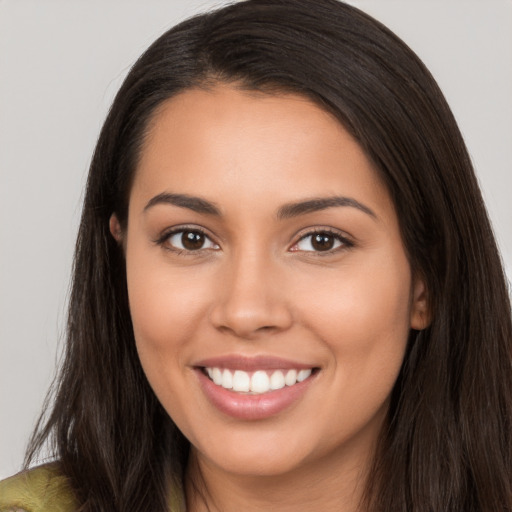 Joyful white young-adult female with long  brown hair and brown eyes