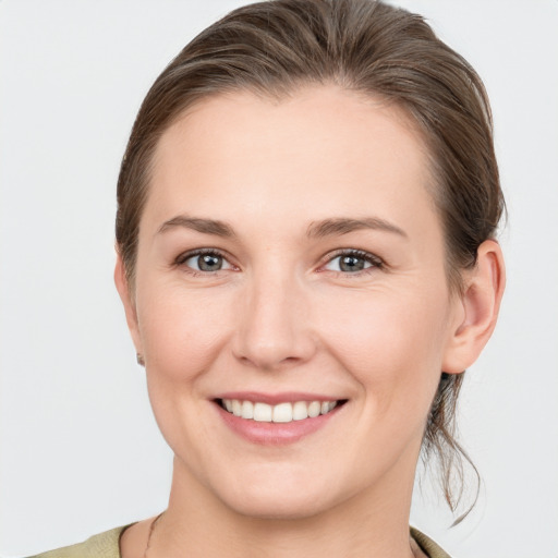 Joyful white young-adult female with medium  brown hair and brown eyes