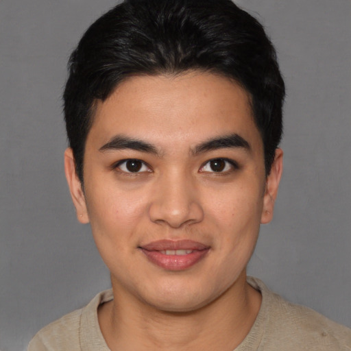 Joyful asian young-adult male with short  brown hair and brown eyes