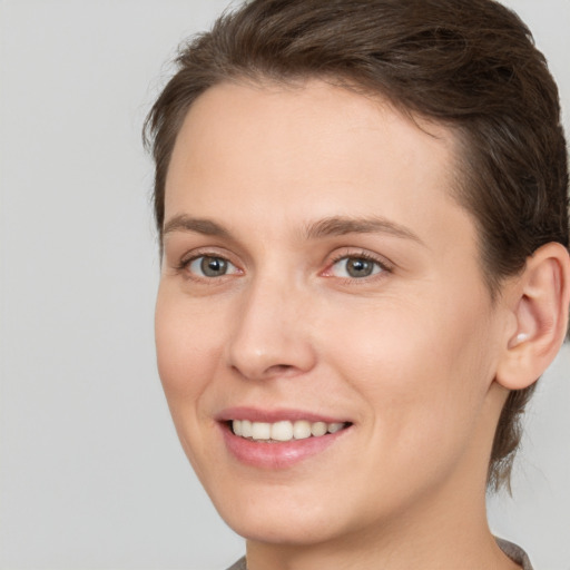 Joyful white young-adult female with medium  brown hair and brown eyes