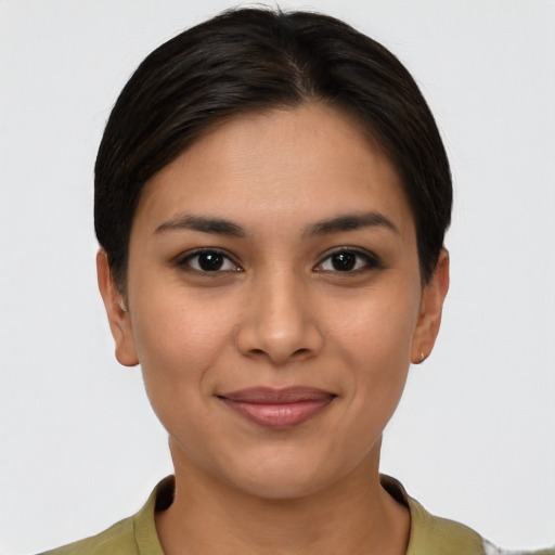 Joyful latino young-adult female with short  brown hair and brown eyes