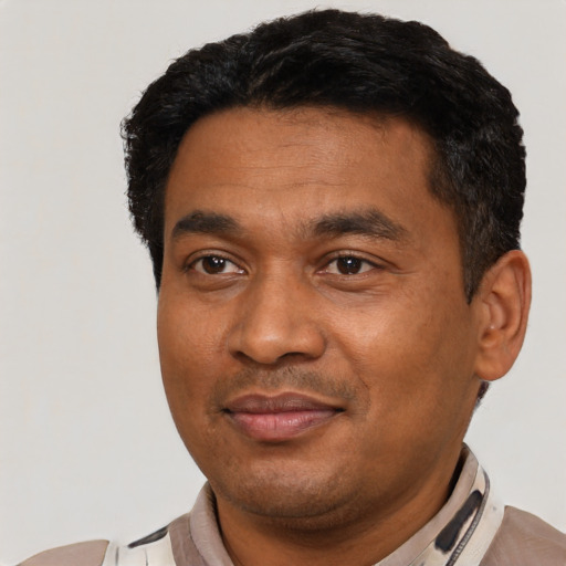 Joyful latino adult male with short  black hair and brown eyes