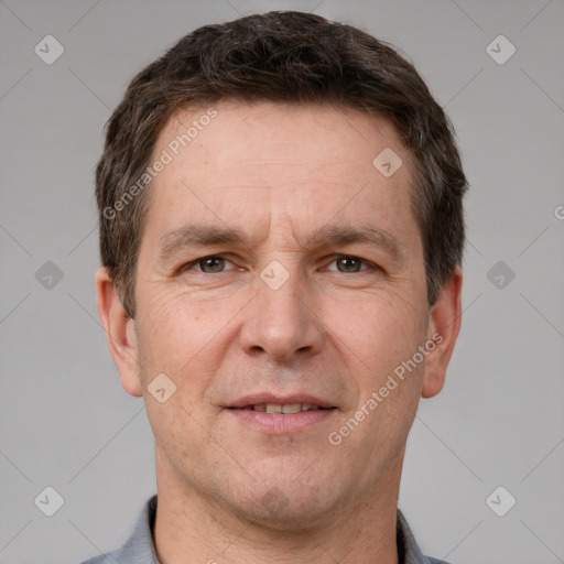 Joyful white adult male with short  brown hair and grey eyes