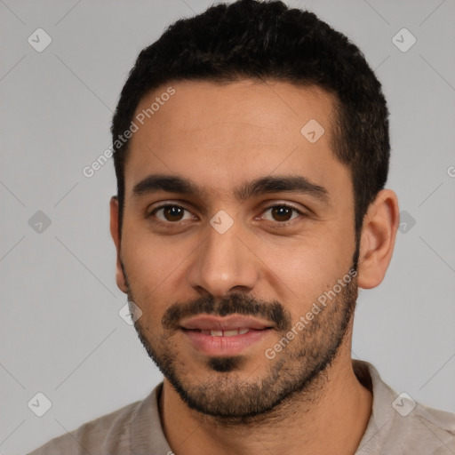 Joyful latino young-adult male with short  black hair and brown eyes