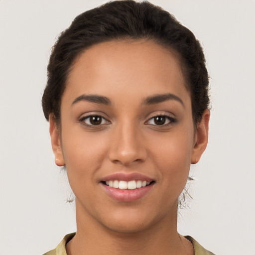 Joyful latino young-adult female with short  brown hair and brown eyes