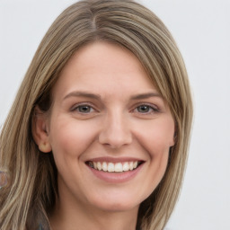 Joyful white young-adult female with long  brown hair and green eyes