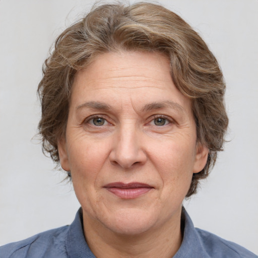 Joyful white middle-aged female with medium  brown hair and grey eyes