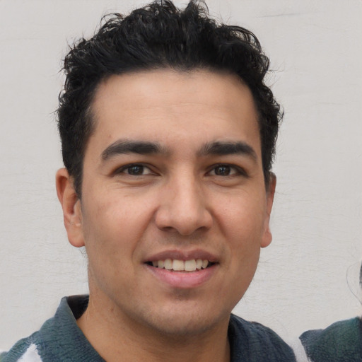 Joyful white young-adult male with short  black hair and brown eyes