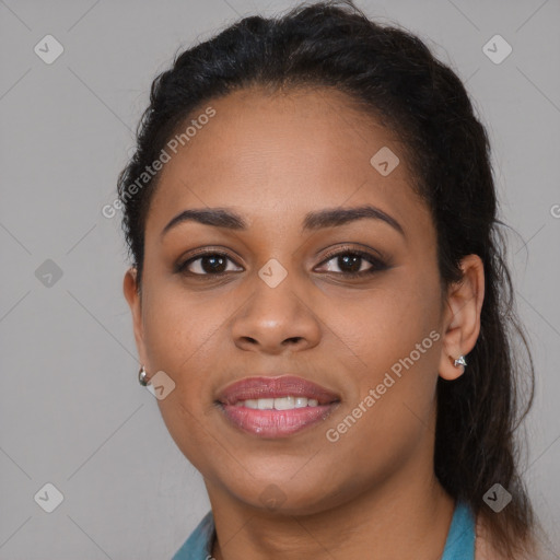 Joyful black young-adult female with long  brown hair and brown eyes