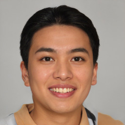 Joyful asian young-adult male with short  brown hair and brown eyes