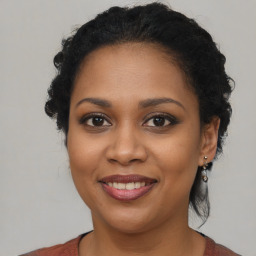 Joyful black young-adult female with medium  brown hair and brown eyes