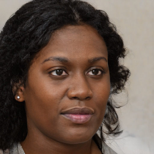 Neutral black young-adult female with medium  brown hair and brown eyes