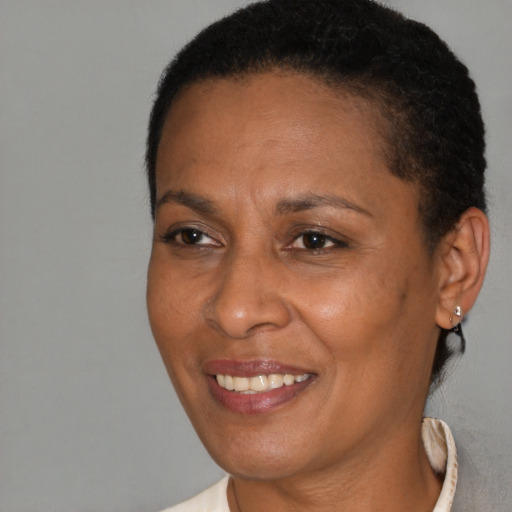 Joyful black adult female with short  brown hair and brown eyes