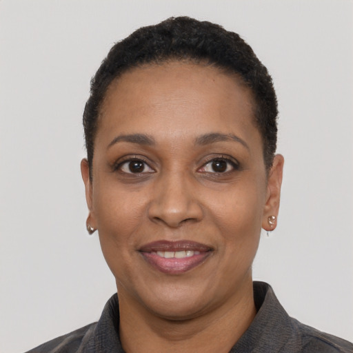 Joyful black adult female with short  black hair and brown eyes