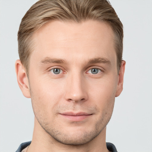 Joyful white young-adult male with short  brown hair and blue eyes