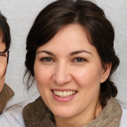 Joyful white adult female with medium  brown hair and brown eyes