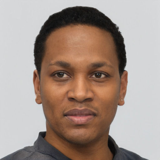 Joyful black young-adult male with short  black hair and brown eyes