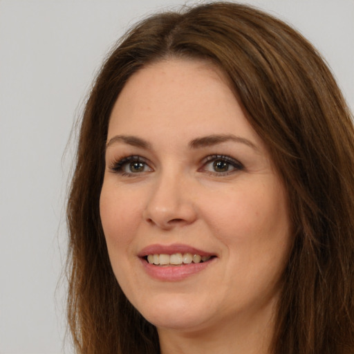 Joyful white young-adult female with long  brown hair and brown eyes