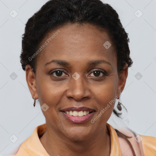 Joyful black adult female with short  brown hair and brown eyes