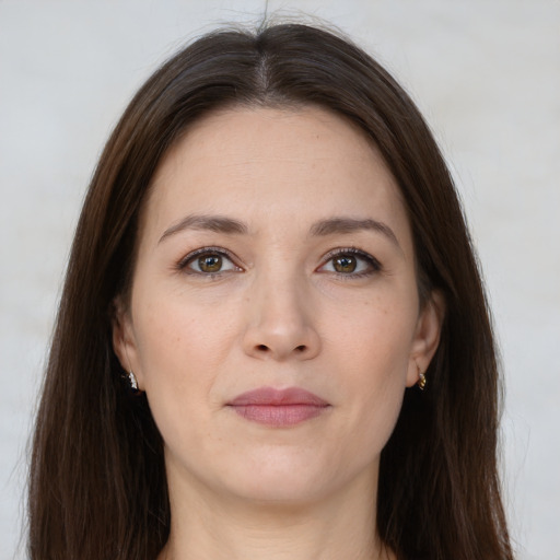 Joyful white young-adult female with long  brown hair and brown eyes