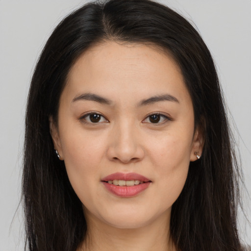 Joyful asian young-adult female with long  brown hair and brown eyes