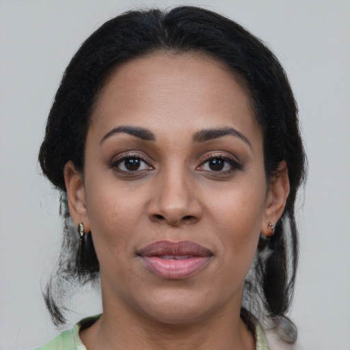 Joyful black young-adult female with medium  brown hair and brown eyes