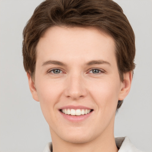 Joyful white young-adult female with short  brown hair and grey eyes