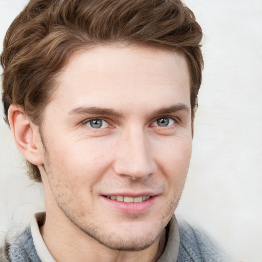 Joyful white young-adult male with short  brown hair and blue eyes