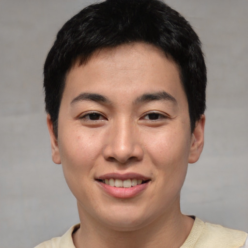 Joyful asian young-adult male with short  black hair and brown eyes