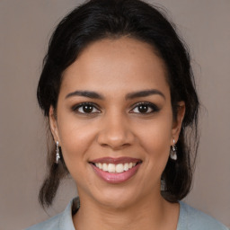 Joyful latino young-adult female with medium  brown hair and brown eyes