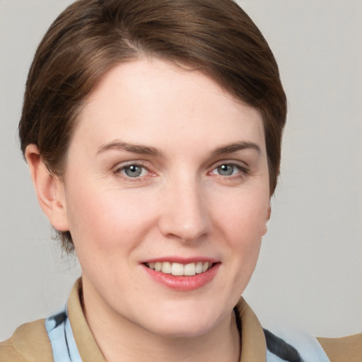 Joyful white young-adult female with medium  brown hair and grey eyes