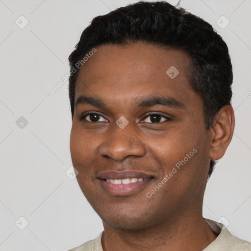 Joyful black young-adult male with short  black hair and brown eyes