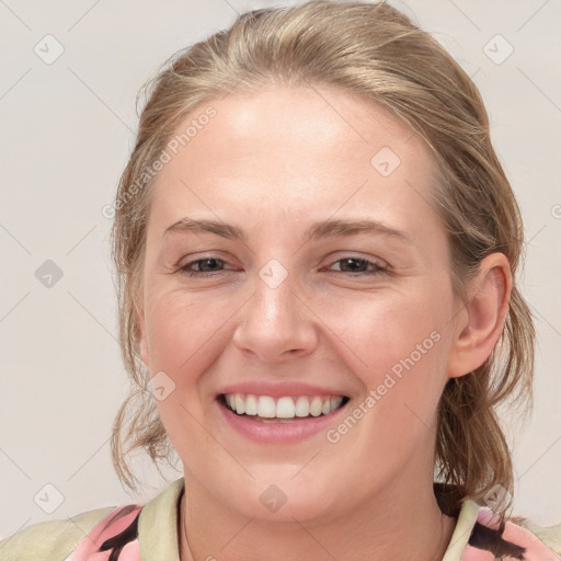 Joyful white young-adult female with medium  brown hair and blue eyes