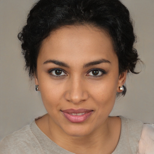 Joyful latino young-adult female with short  brown hair and brown eyes
