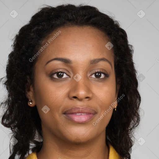 Joyful black adult female with long  brown hair and brown eyes