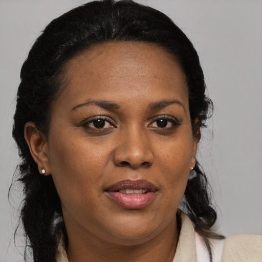 Joyful black adult female with medium  black hair and brown eyes