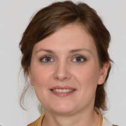 Joyful white young-adult female with medium  brown hair and brown eyes