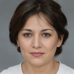 Joyful white adult female with medium  brown hair and brown eyes