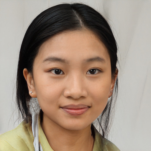 Joyful asian young-adult female with medium  black hair and brown eyes
