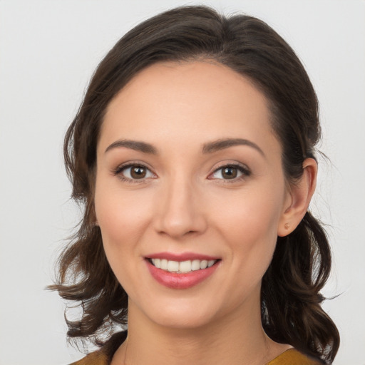 Joyful white young-adult female with medium  brown hair and brown eyes