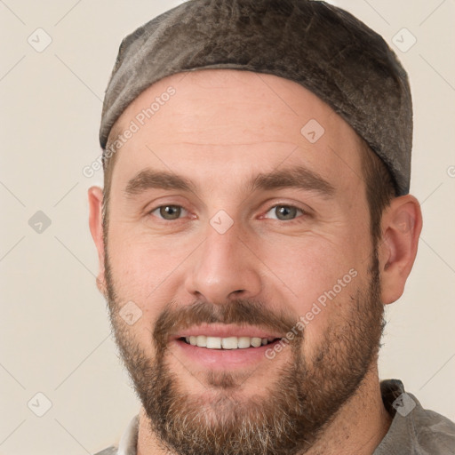 Joyful white adult male with short  brown hair and brown eyes