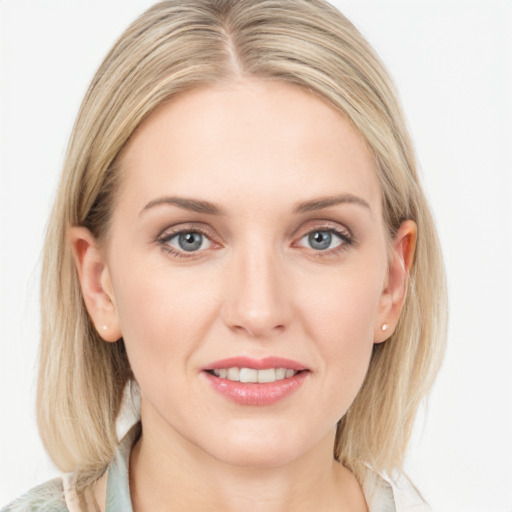 Joyful white young-adult female with long  brown hair and blue eyes