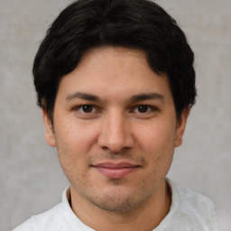 Joyful white young-adult male with short  black hair and brown eyes