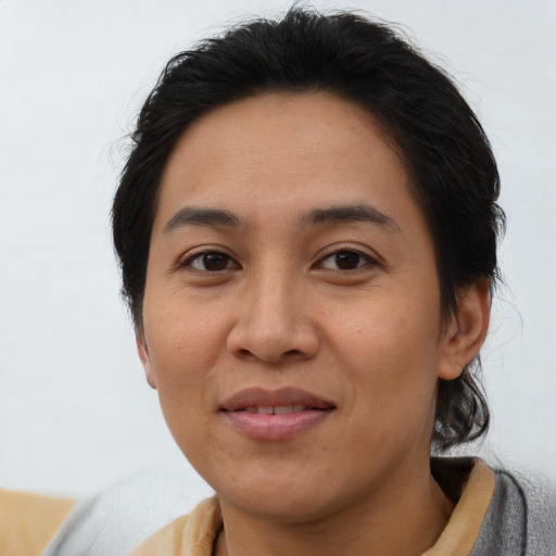 Joyful asian young-adult female with medium  brown hair and brown eyes