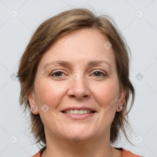 Joyful white adult female with medium  brown hair and grey eyes