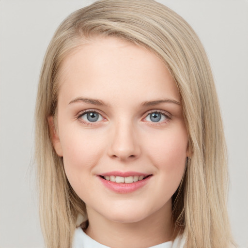 Joyful white young-adult female with long  brown hair and blue eyes