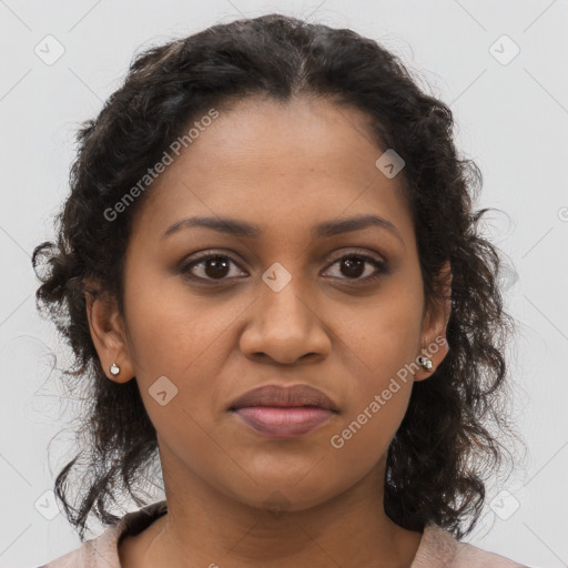 Joyful black young-adult female with long  brown hair and brown eyes