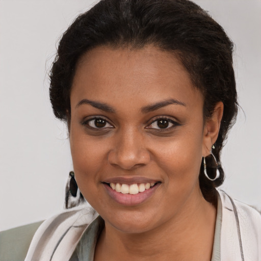 Joyful black young-adult female with medium  brown hair and brown eyes