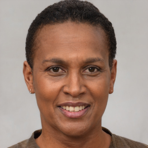 Joyful black adult female with short  brown hair and brown eyes